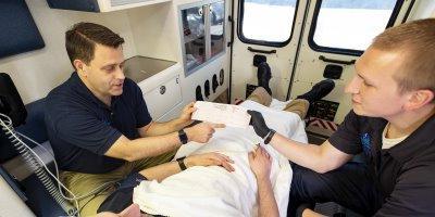 EMS professionals care for a patient in an ambulance
